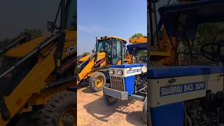 Jcb 3dx machine loading mud in swaraj tractor trolley for construction shorts