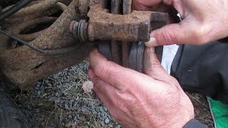 Replacing rear brake pads and lubricating caliper slide pins on a vehicle with disk brakes