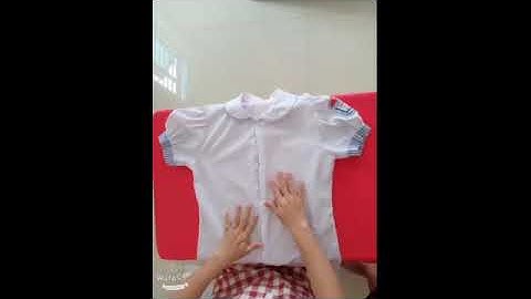dạy trẻ cài , cởi cúc áo
