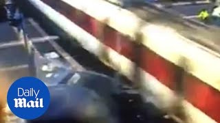 CCTV footage captures moment drunk driver smashes Range Rover into train at level crossing