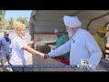 Sikh community members hand out hot lunch meals to homeless