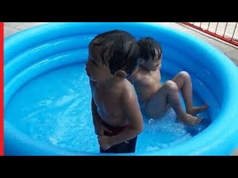 SWIMMING IN A PORTABLE POOL BABY BOY WHO'S ABOUT TO PEE