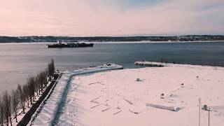 Drone over snowy St. Lawrence River (Quebec)