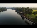 Idyllic view a lake with floating house boat with tropical forest in kerala alleppey india