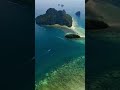 🌊 Daytime Delight: Mesmerizing Seaside Scenery Amidst Rolling Mountains ⛰️