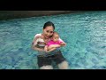 Baby mish playing with beautiful mom in the pool