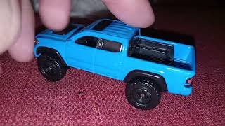 Solid Blue GMC Hummer EV , Toyota Tacoma