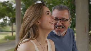 A Mature Couple Sits Closely On A Park Bench, Sharing A Lovely Conversation At The Park