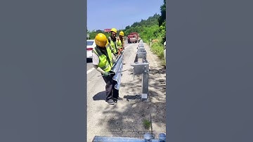 Road Guardrail Installation: Workers Collaborate for Safe Driving