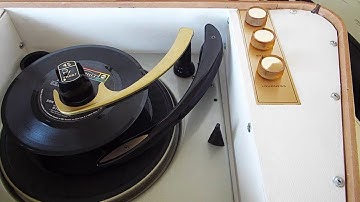 Magnavox STEREO portable record player playing a stack of 45 RPM record