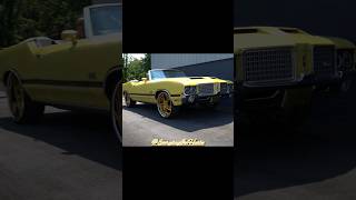 Back-to-back Oldsmobile 442 verts: Forgiato&#39;s on the white/gold &amp; Savini&#39;s on the yellow one