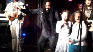 Elizabeth and Isabel sing Three Little Birds on stage