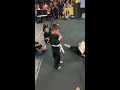 Children in Karate Class Cheer Kid on While Kicking Board - 1042142