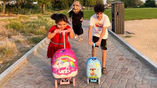 Children play on scooters in the park