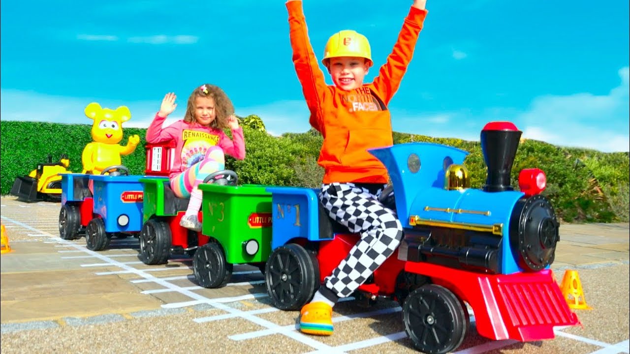 Katy and Max have fun with outdoor toys