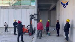 Electric wall panel erecting and installing machine working on the construction site