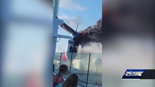 Flames, black smoke come out of Carnival cruise ship's funnel while docked in Grand Turk