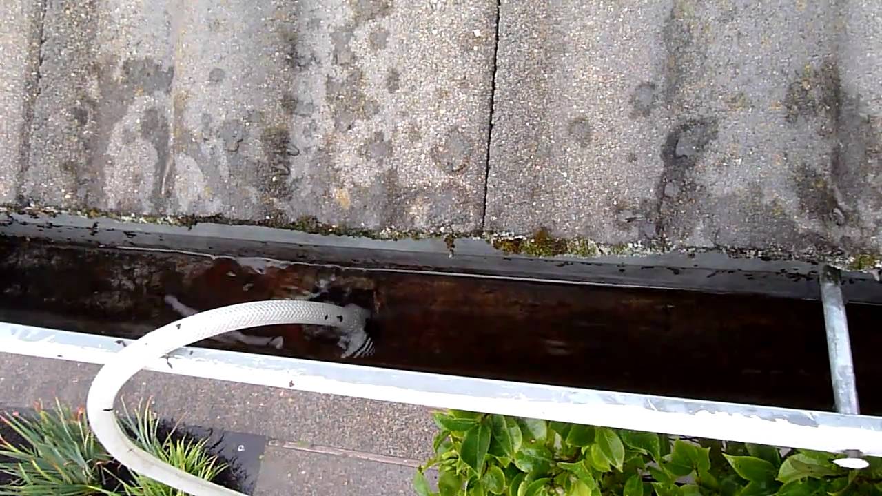 How can I clear a clogged downspout?
