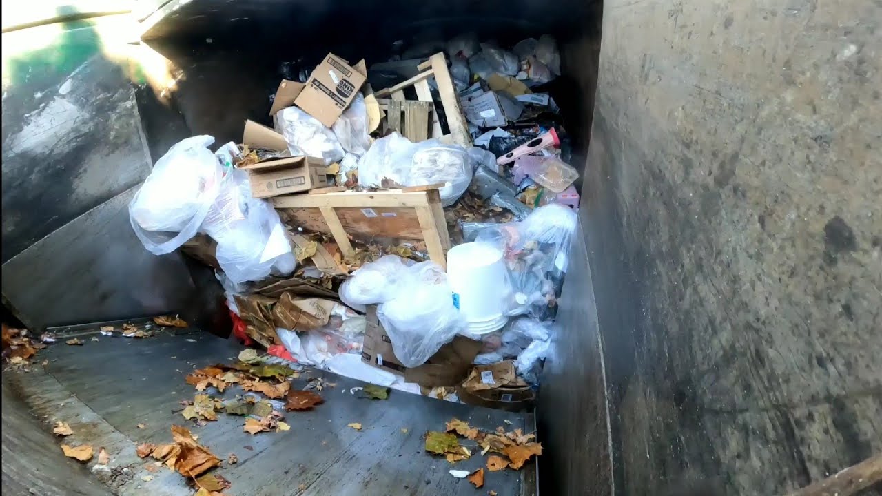 Waste Management garbage truck packing garbage