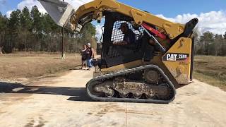 Cat 259D skid steer spreading gravel