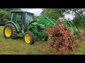 Greg is using tractor grapples to clear brush.