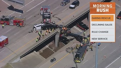 Video captures the cab of a tow truck dangling on an overpass