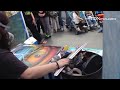 P. Annabelli works on a piece of spray paint art.