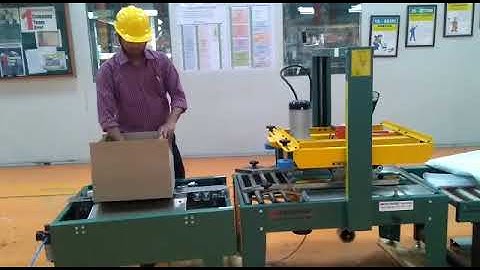 SIGNODE MAKE CARTON TAPING MACHINE WITH AUTOMATIC BOTTOM FLAP CLOSED