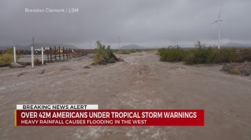 Rains from Tropical Storm Hilary swamp roads, trap cars and flood buildings