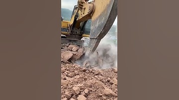 Excavator ripping the rock