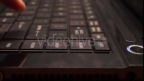 Black Keyboard and One Finger Pressing Buttons.