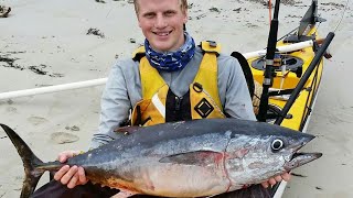 Offshore kayak fishing for southern bluefin tuna in portland, victora,
australia. having just handed off one rod to another fisherman (during
a souther...