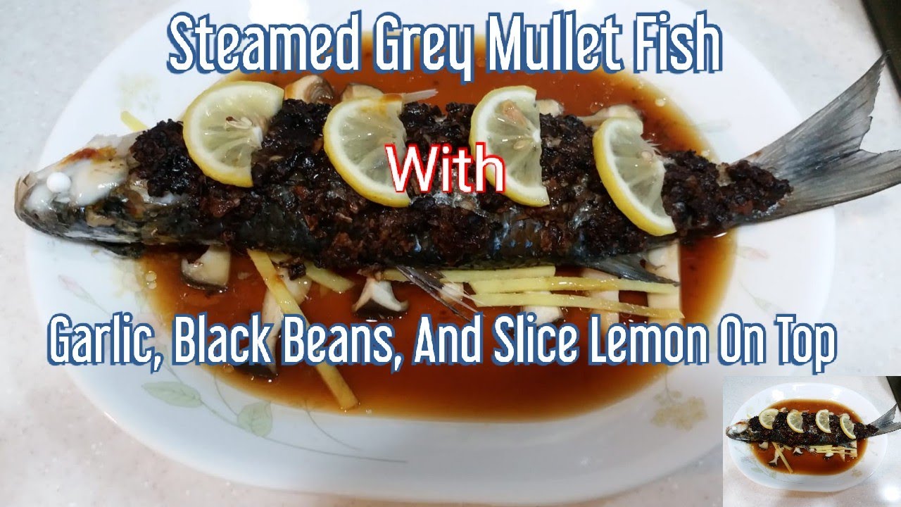 Steamed Grey Mullet Fish With Garlic, Black Beans, And Lemon On Top