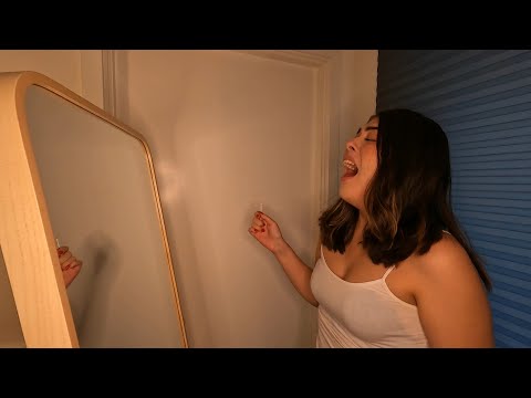 Girl spraying sneezes on a mirror