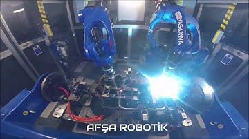 Welding Cell with 2 robots and 3 axis turn table positioner..