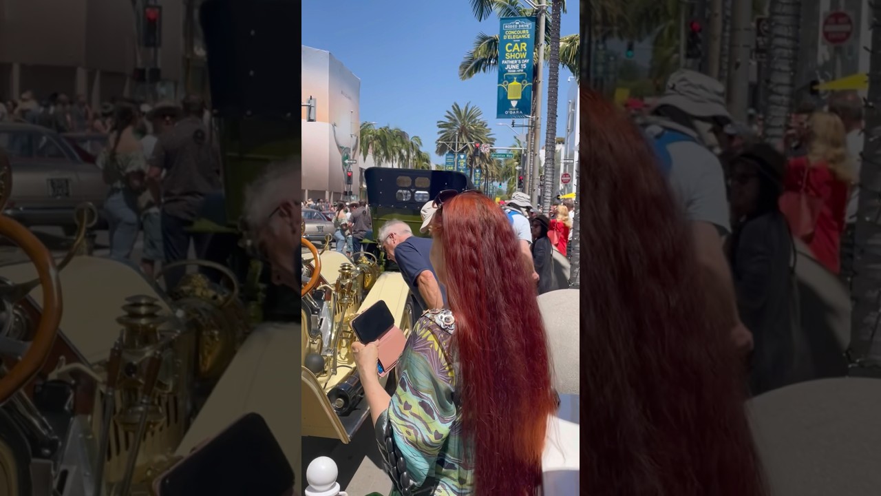 Beauty of long red hair. Sarah Goldberg at car show 
