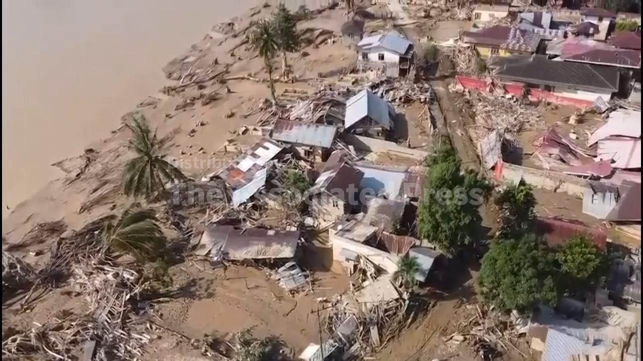 Damaged roads and debris slow relief operations after deadly floods in Indonesia