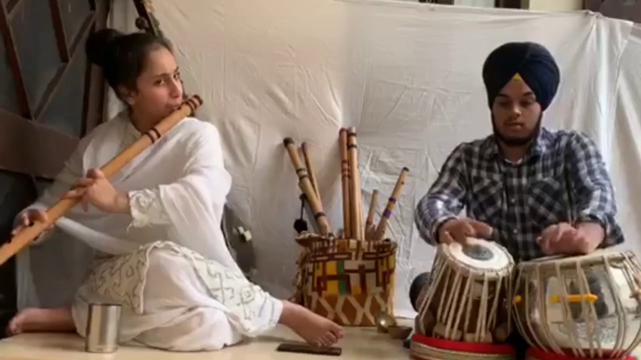 Young girls playing instrument Flute. Indian Classical musical