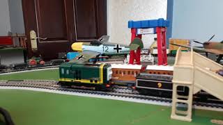 Bachmann Edward pulling flatbed truck with Trevor on top and Brakevan