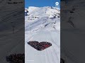 Skiers in Switzerland form a heart in honor of people killed in New Year's fire