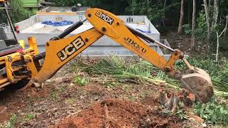 jcb 3dx digging out roots of trees