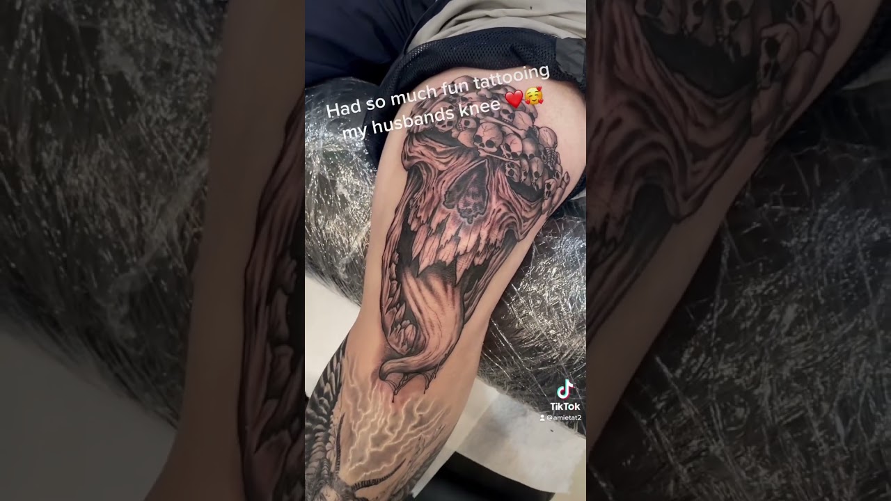 Demon and skulls blackwork knee tattoo