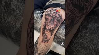 Demon and skulls blackwork knee tattoo