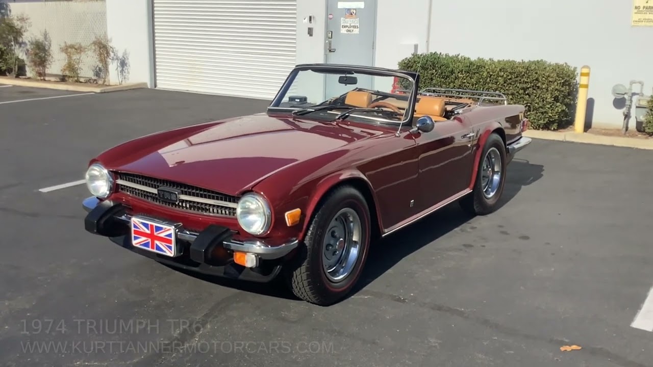 1974 TRIUMPH TR6. CARMINE RED WITH TAN INTERIOR AND SOFT TOP. FOUR