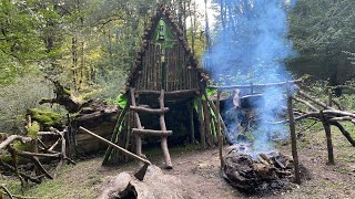Building Complete And Warm Bushcraft Survival Shelter On A Fallen Trunk, Waterproof Hut, Fireplace