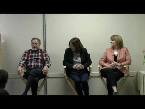 George Pransky, Linda Pransky, and Barb Patterson sitting on chairs speaking at a conference. 