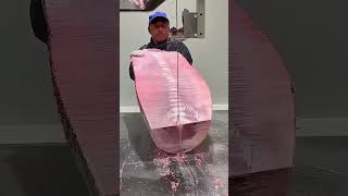Why is the head of the tuna fish cut first before slicing it?