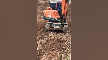 Excavator Operator Trimming Slope Skills