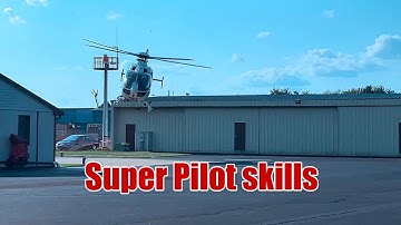 Unreal Precision: Helicopter Lands Between Two Hangars