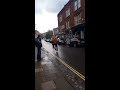 Cyclist carries child precariously on hip - with neither wearing a helmet